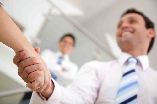 Business man handshaking a person in an office